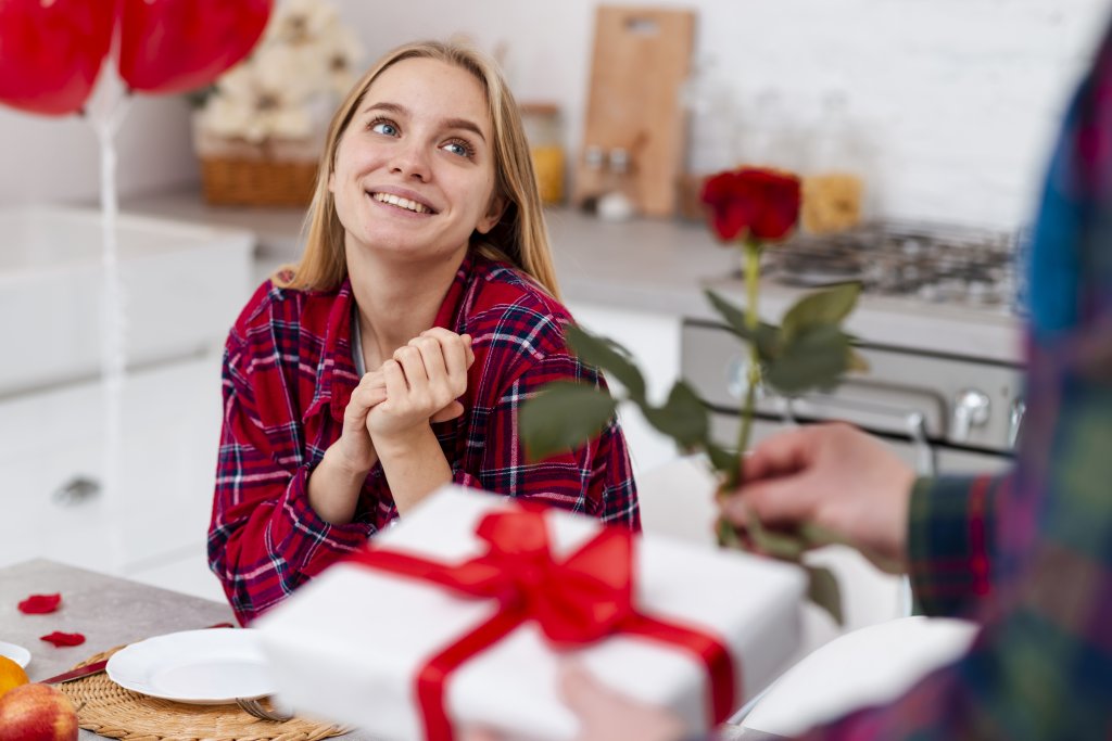 close-up-man-surprising-woman-with-rose-and-present.jpg