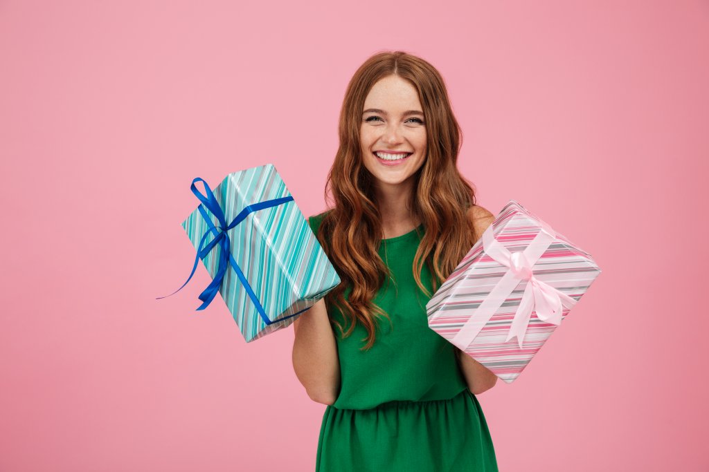 portrait-of-a-happy-woman-in-dress-holding-present-boxes.jpg