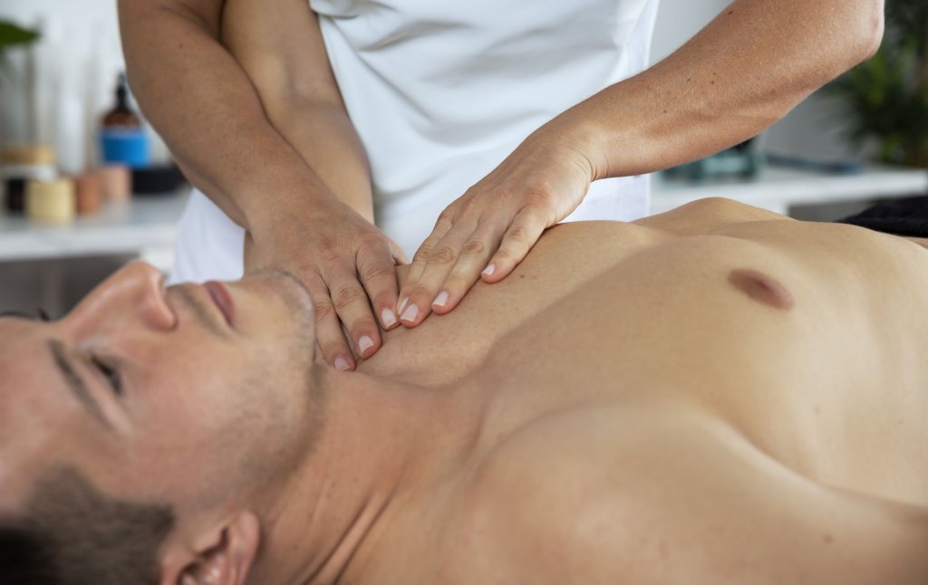physiotherapist-performing-therapeutic-massage-male-client.jpg