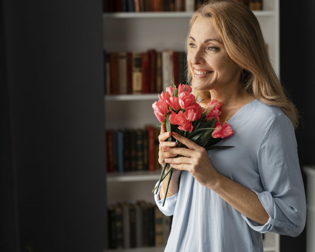 mid-shot-woman-counselor-holding-flowers-bouquet.jpg